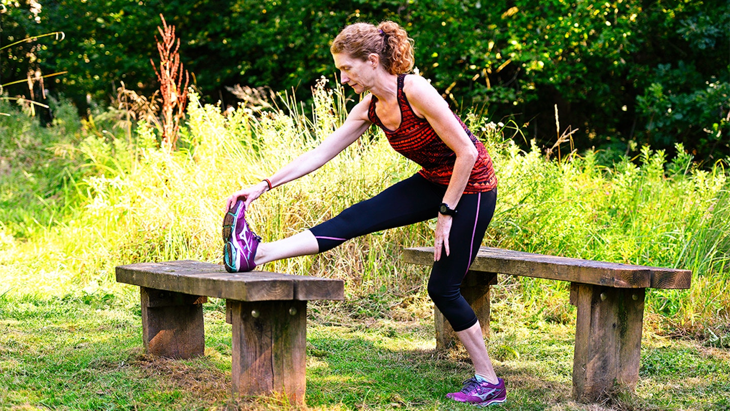 woman stretching in a forest