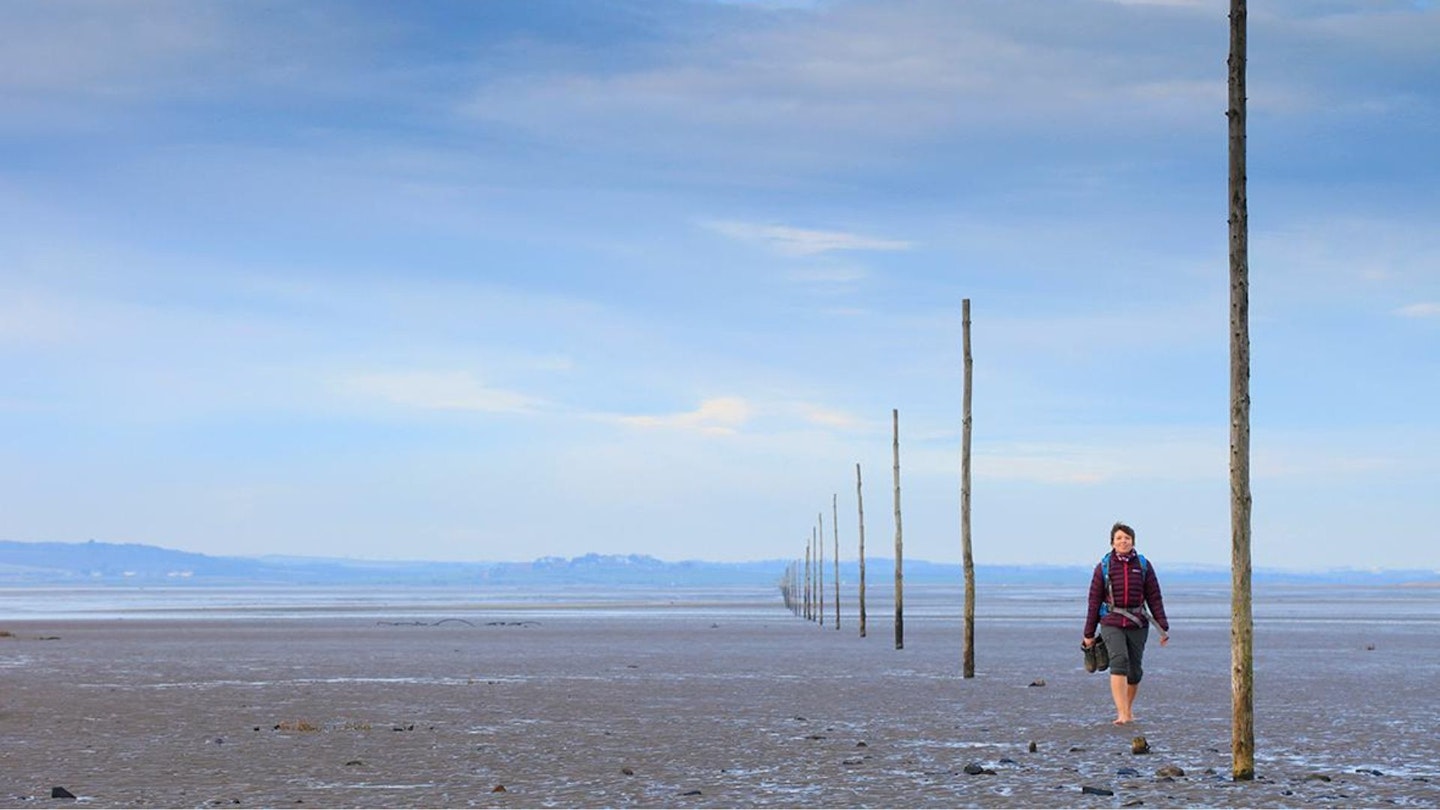 Walker crossing to Holy Island Northumberland Coast