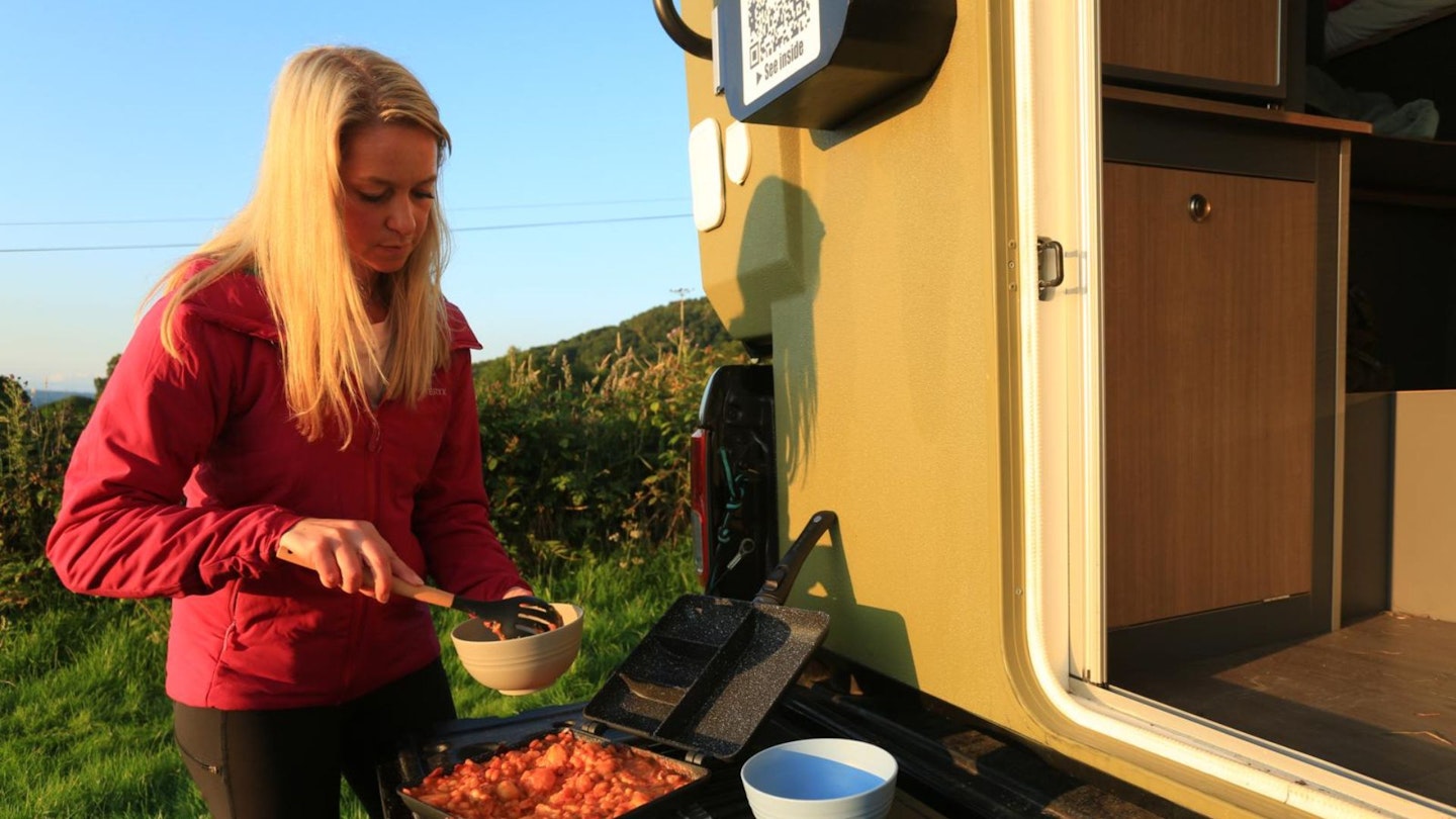 tester ellie makes breakfast while camping