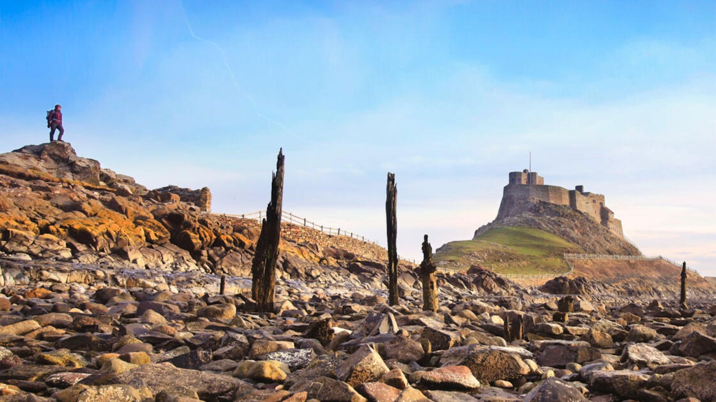 Walking heading for Lindisfarne castle Holy Island Northumberland Macs Adventure