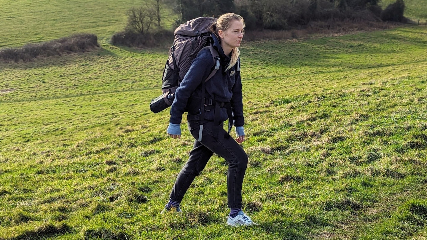 Our tester Kate Milsom walking with the Decathlon Forclaz Women's Travel 900 60+6L Backpack