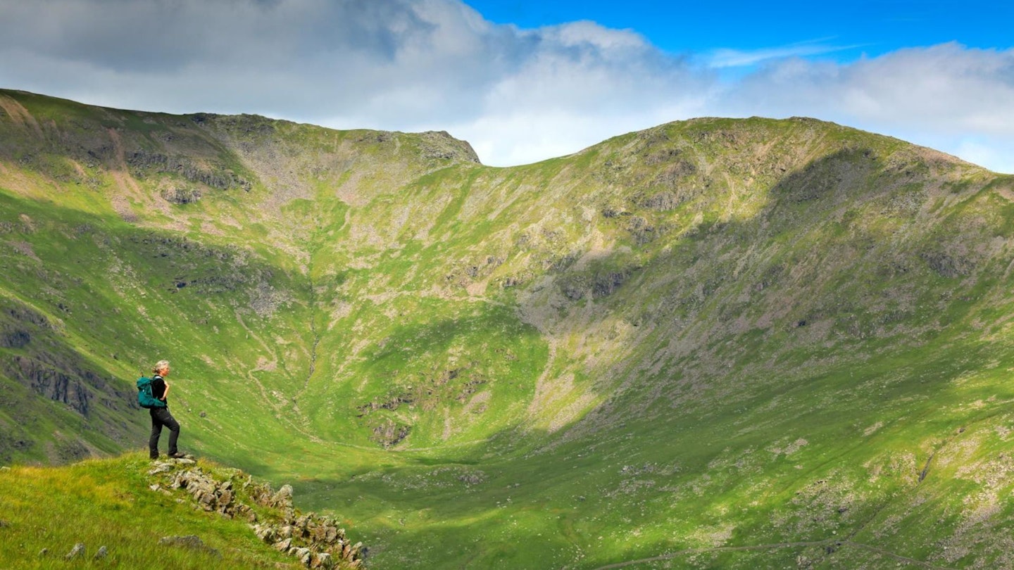 Hiker looking to Fairfield and Rydal Head from high on Heron Pike Fairfield Horseshoe