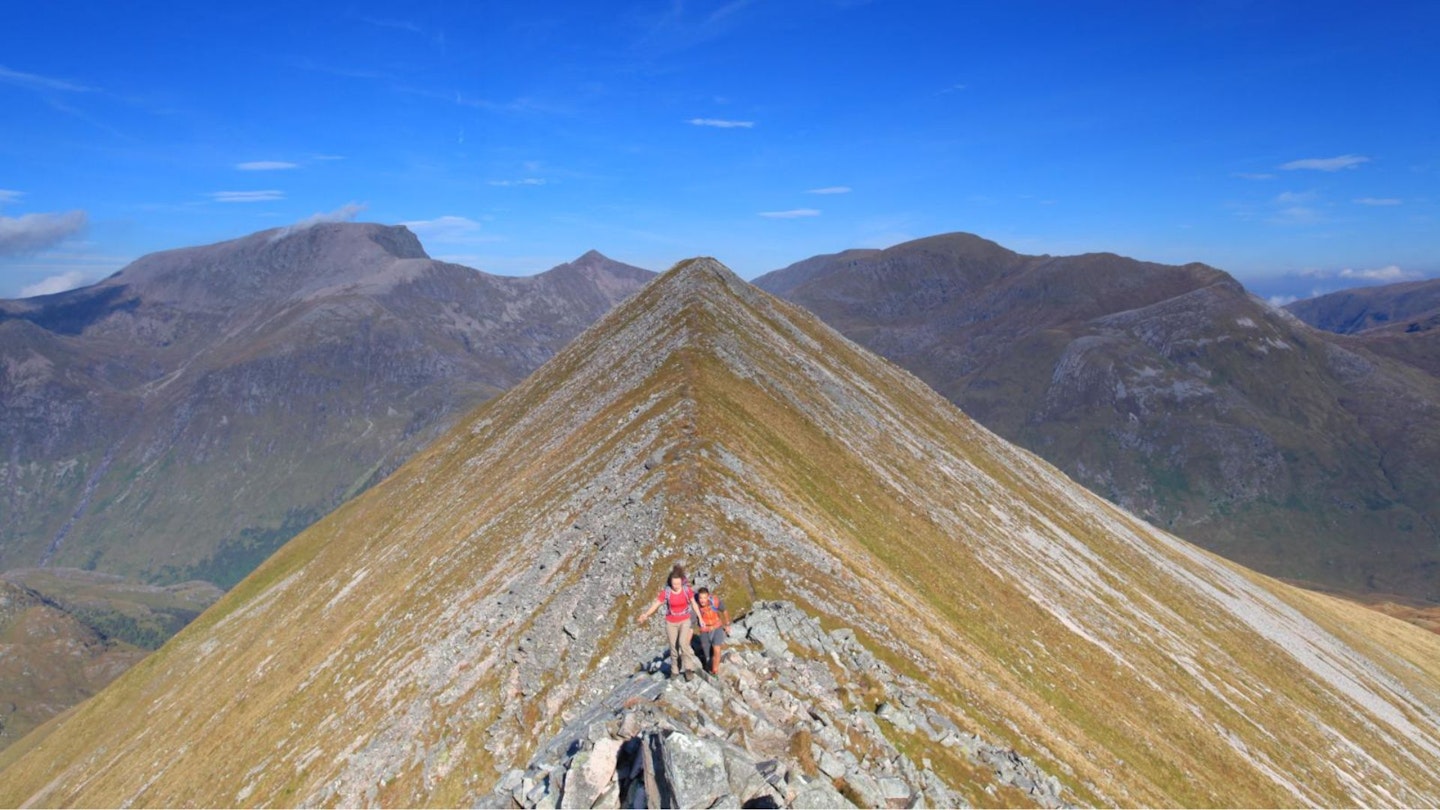 Hikers heading from An Gearanach towards Stob Coire Chairn Ring of Steall Glen Nevis Scotland