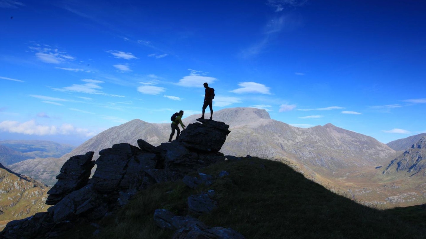 Hikers high on An Gearanach looking over to Ben Nevis Ring of Steall Glen Nevis Scotland
