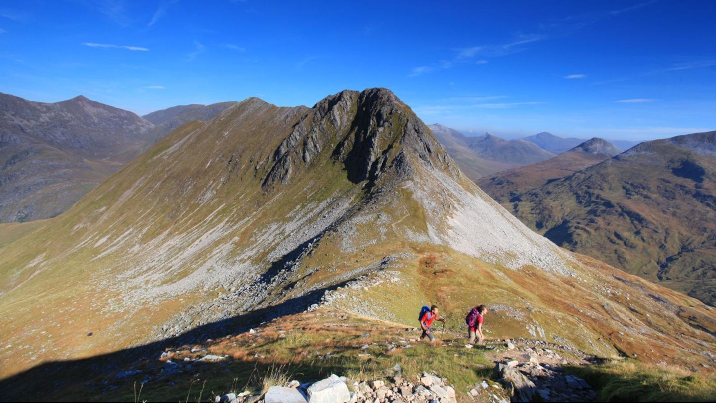 Hikers heading from An Gearanach towards Stob Coire Chairn Ring of Steall Glen Nevis Scotland