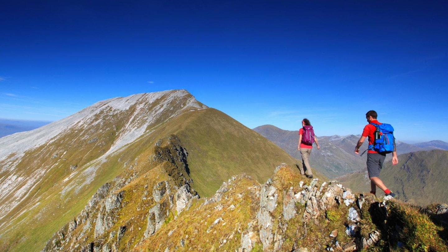 Hiker on Stob Coire Mhail heading for Sgurr a Mhaim Ring of Steall Glen Nevis Scotland