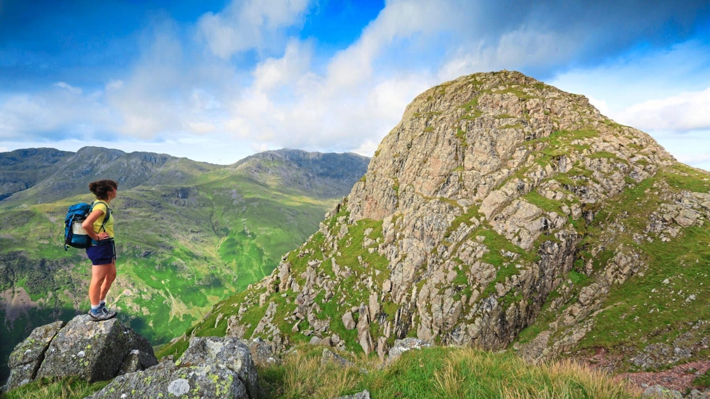 Female walker looking at Pike of Blisco Langdale Pikes Lake District