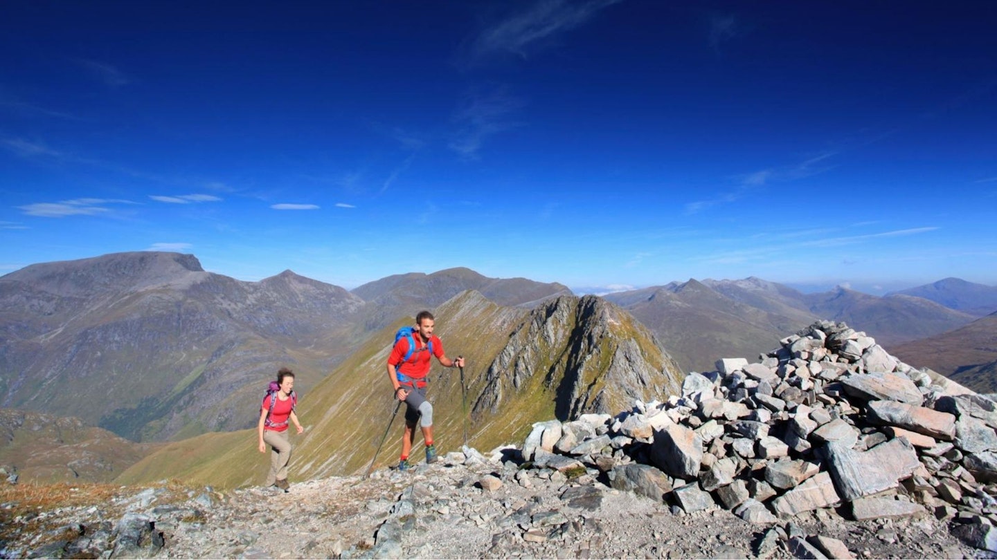 Two hikers on the Ring of Steall Mamores Scottish Highlands with Ben Nevis behind