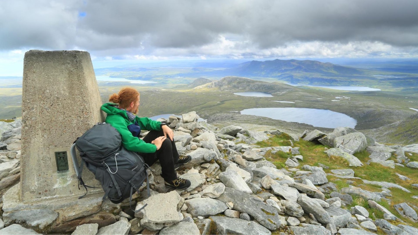 Hiker at the summit of Ben Hope Sutherland