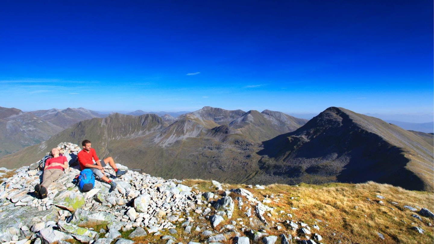 Hikers on the summit of Sgurr an lubhair Ring of Steall Glen Nevis Scotland