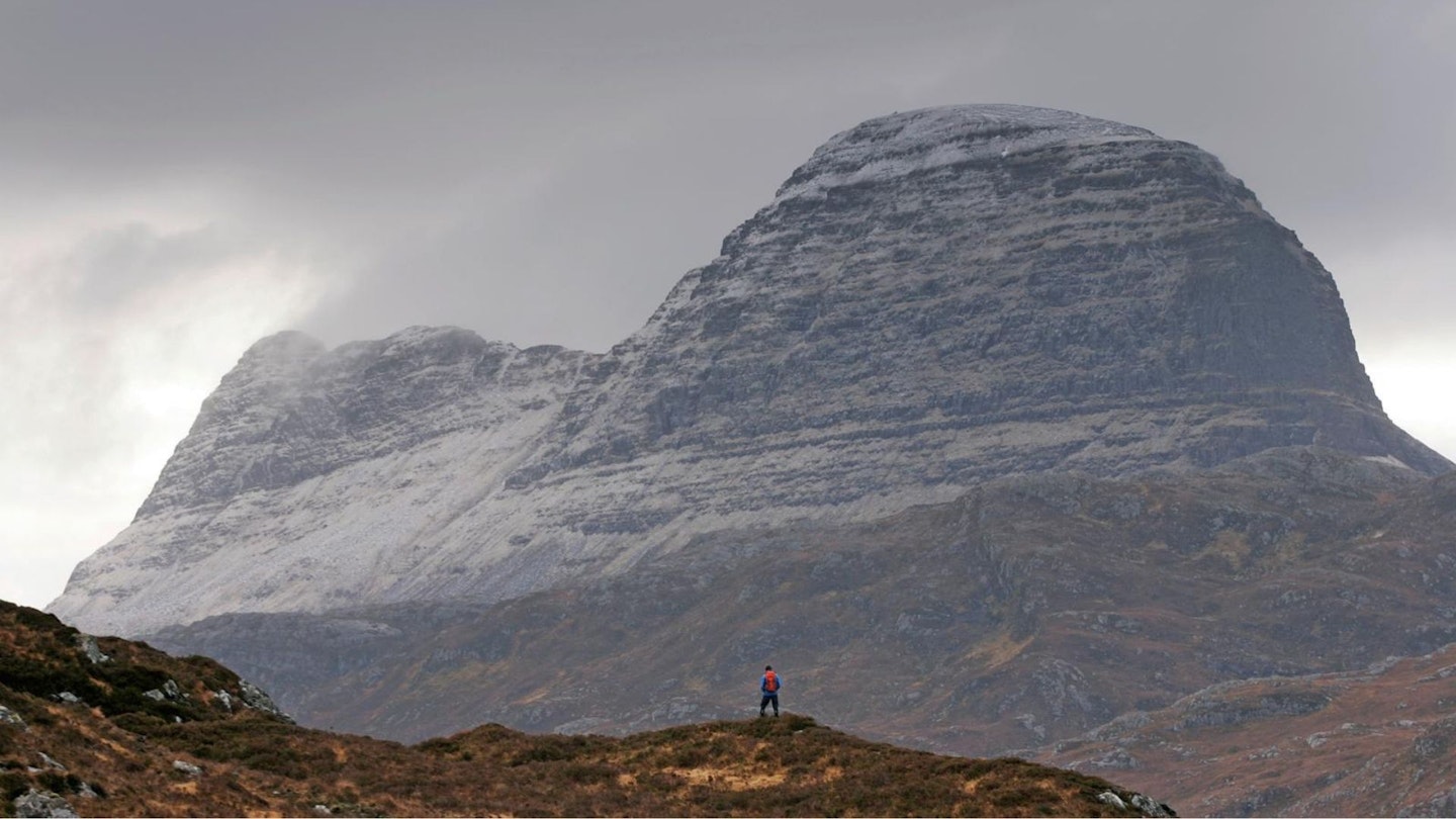Walker in front of Suilven Assynt Scottish Highlands