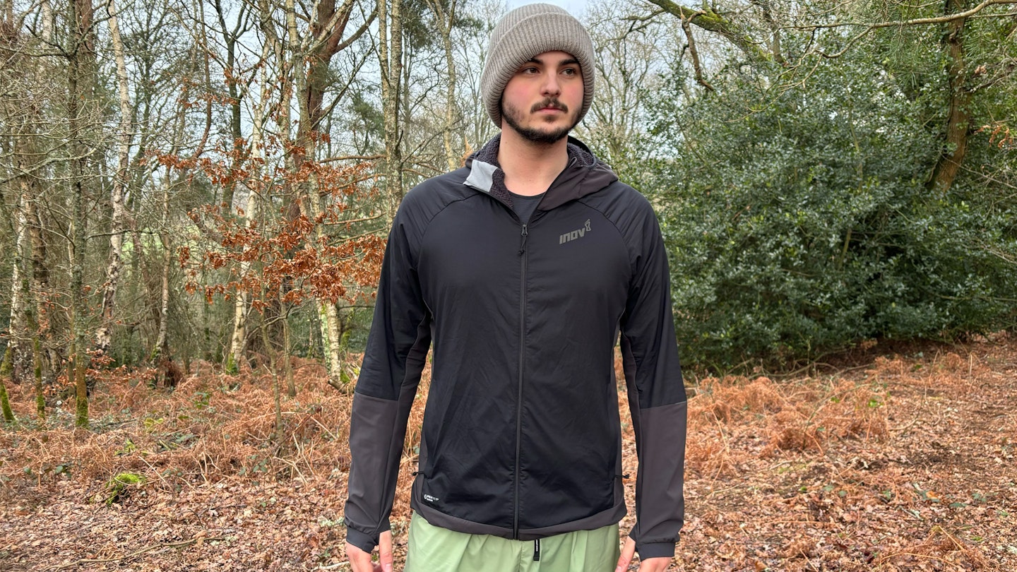 gear reviewer and tester Milo Wilson wearing the inov8 performance hybrid jacket