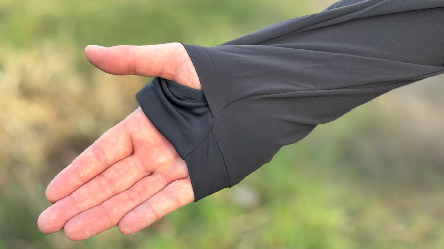 thumb hooks on the sleeve of the inov8 performance hybrid trail running jacket