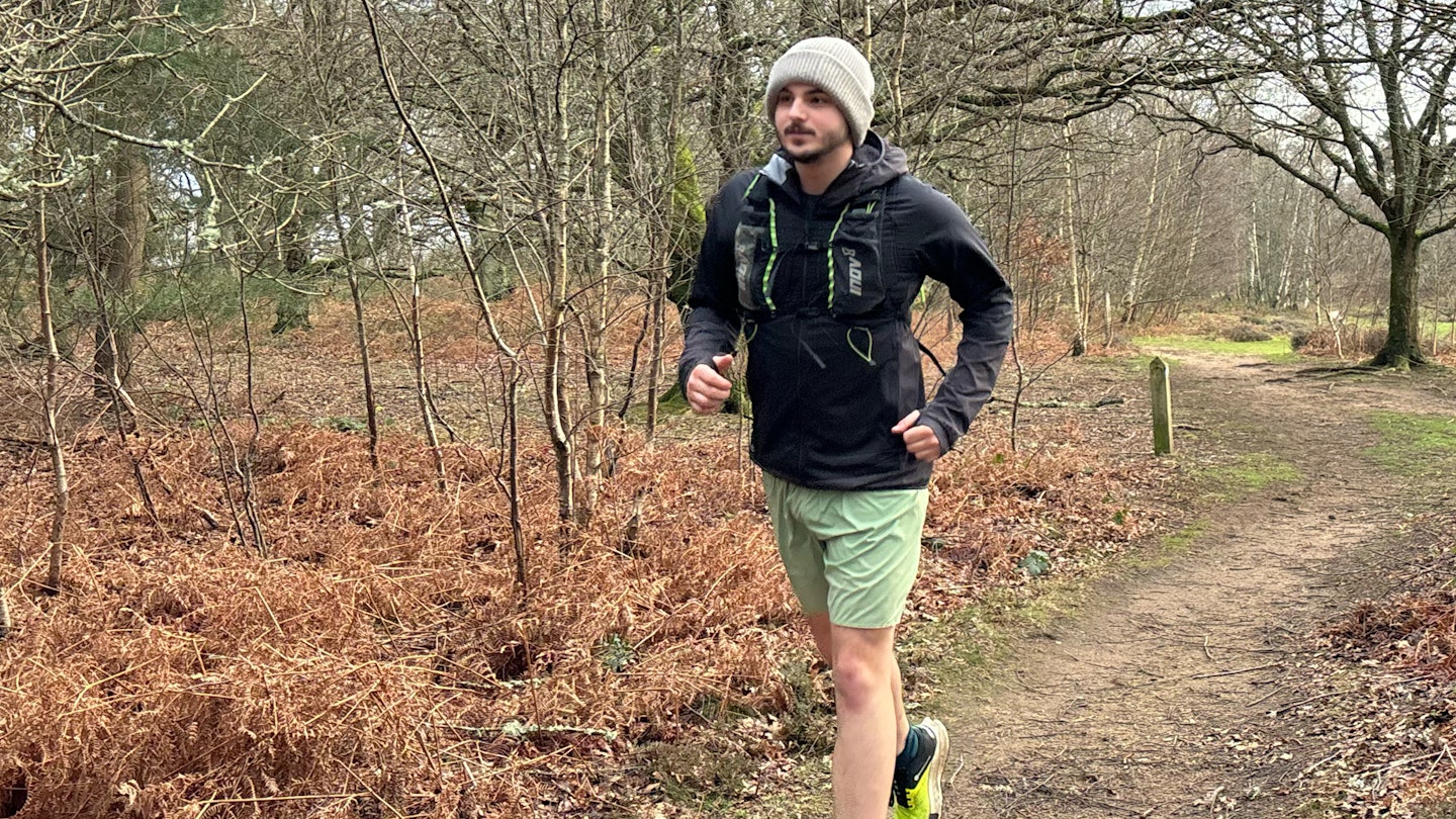 trail runner wearing the inov8 performance hybrid running jacket