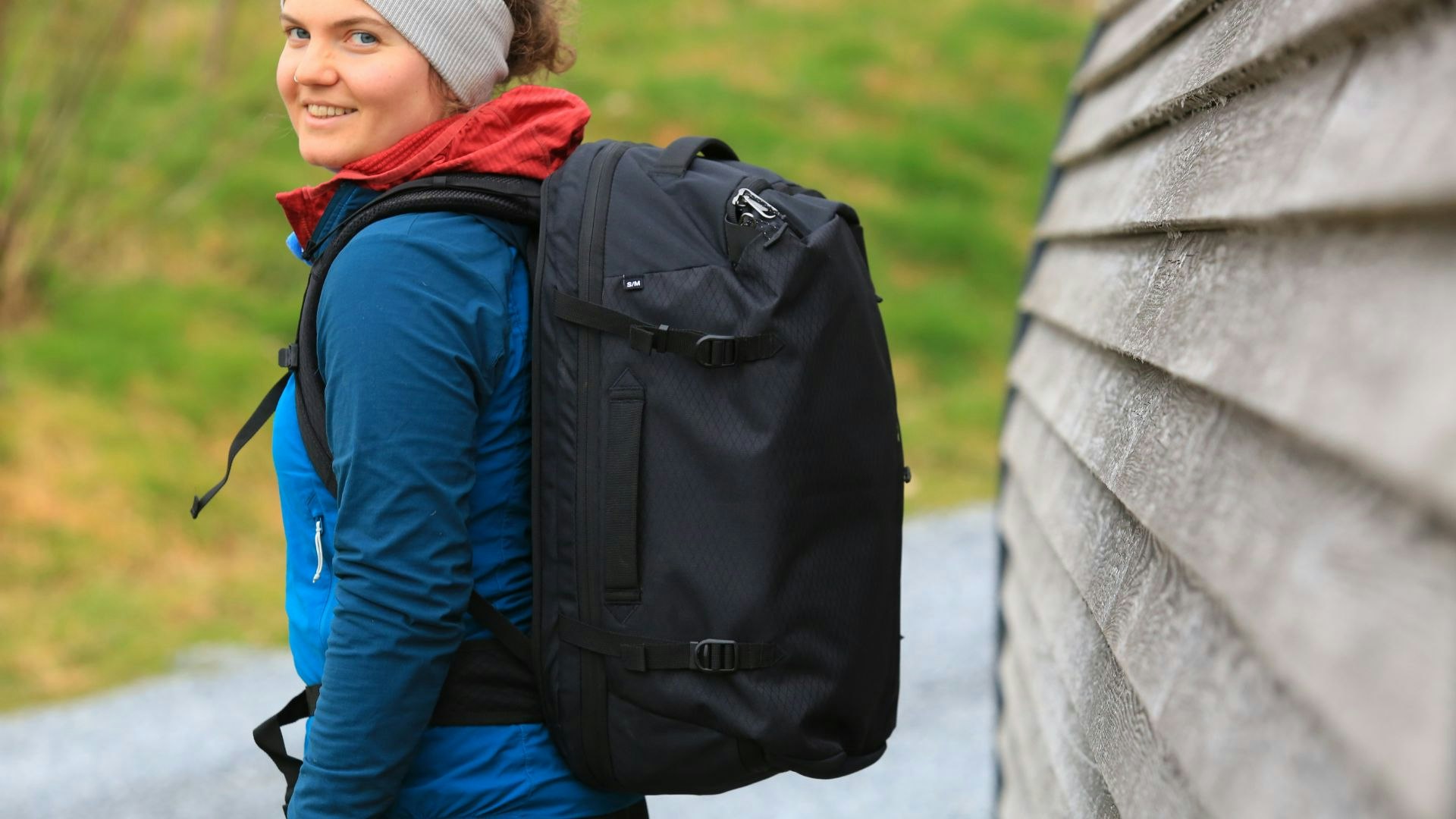 Eagle Creek travel bag worn on a person looking over their shoulder at the camera