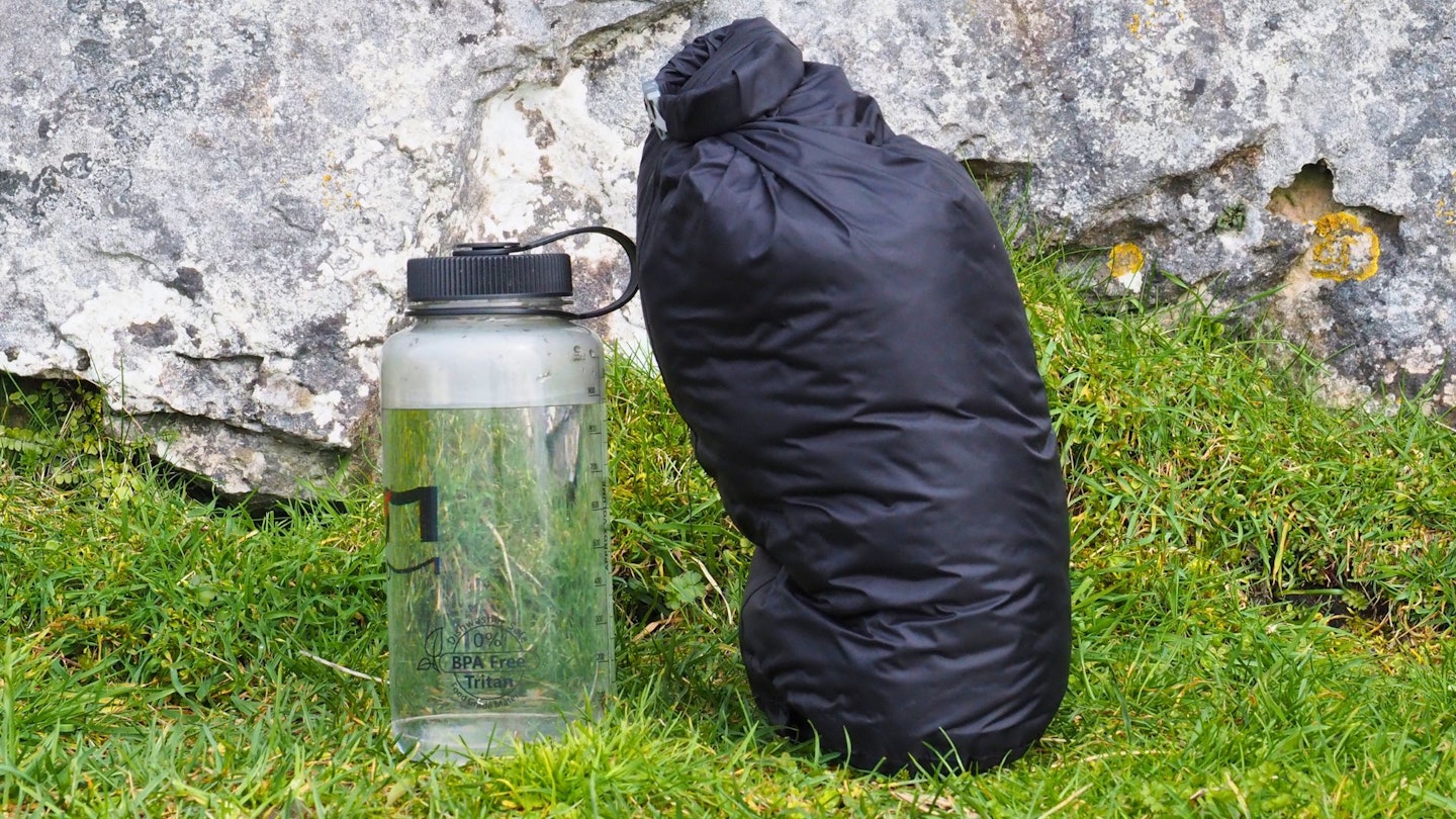Exped Ultra 0 in stuff sack next to a water bottle for scale
