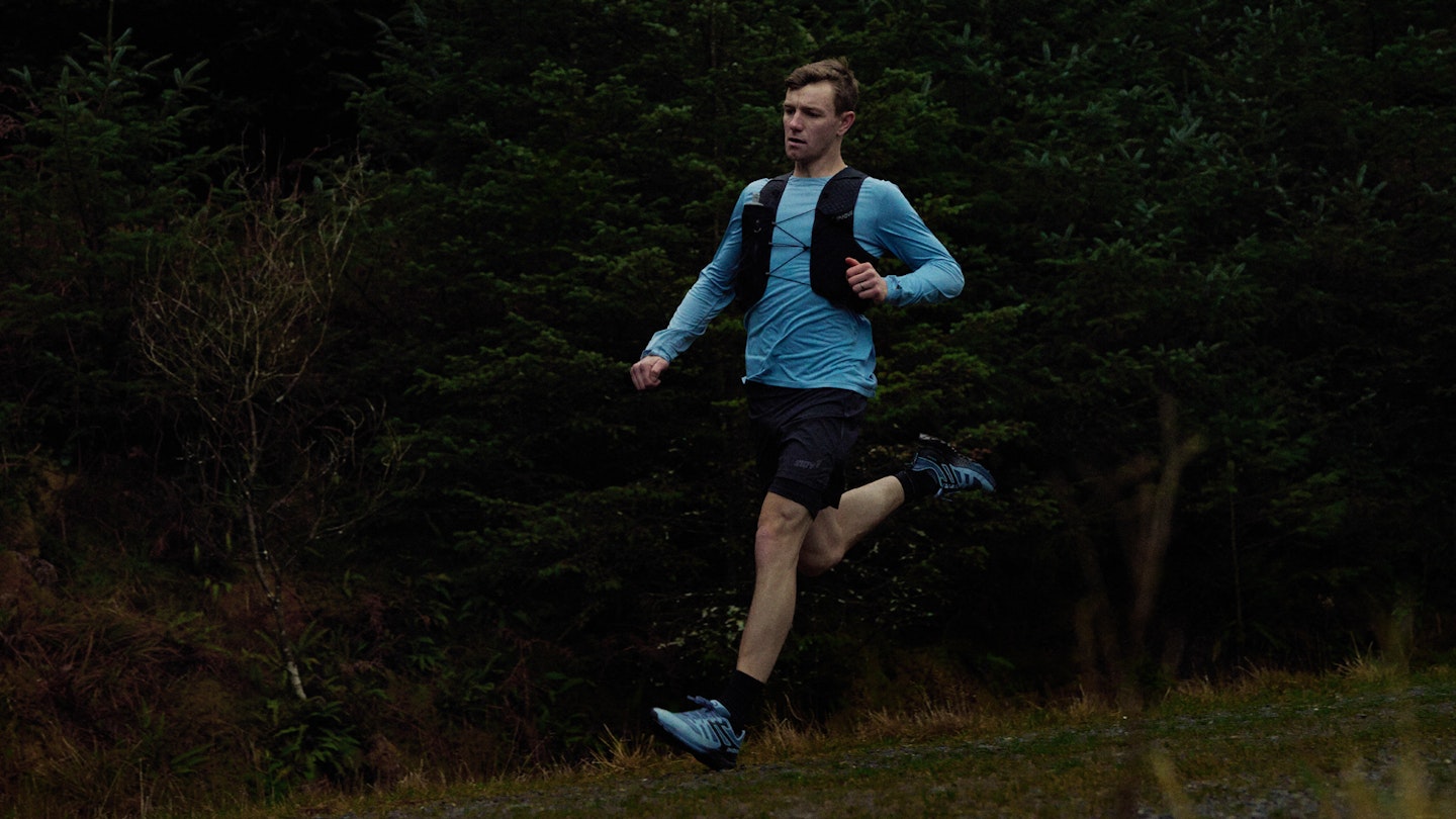 Man trail running wearing inov8 trailfly shoes