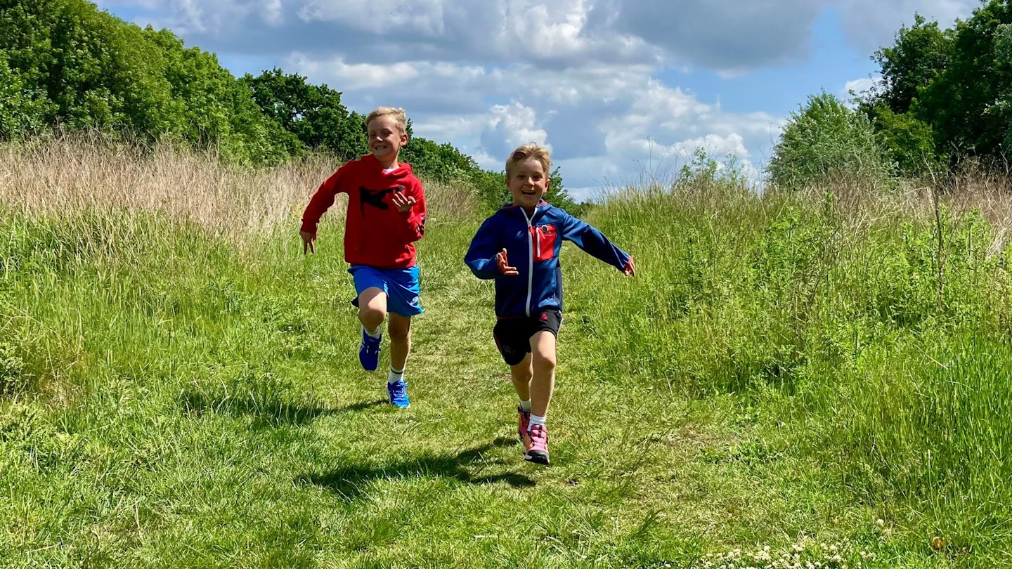 Two young boys running in kids running shoes