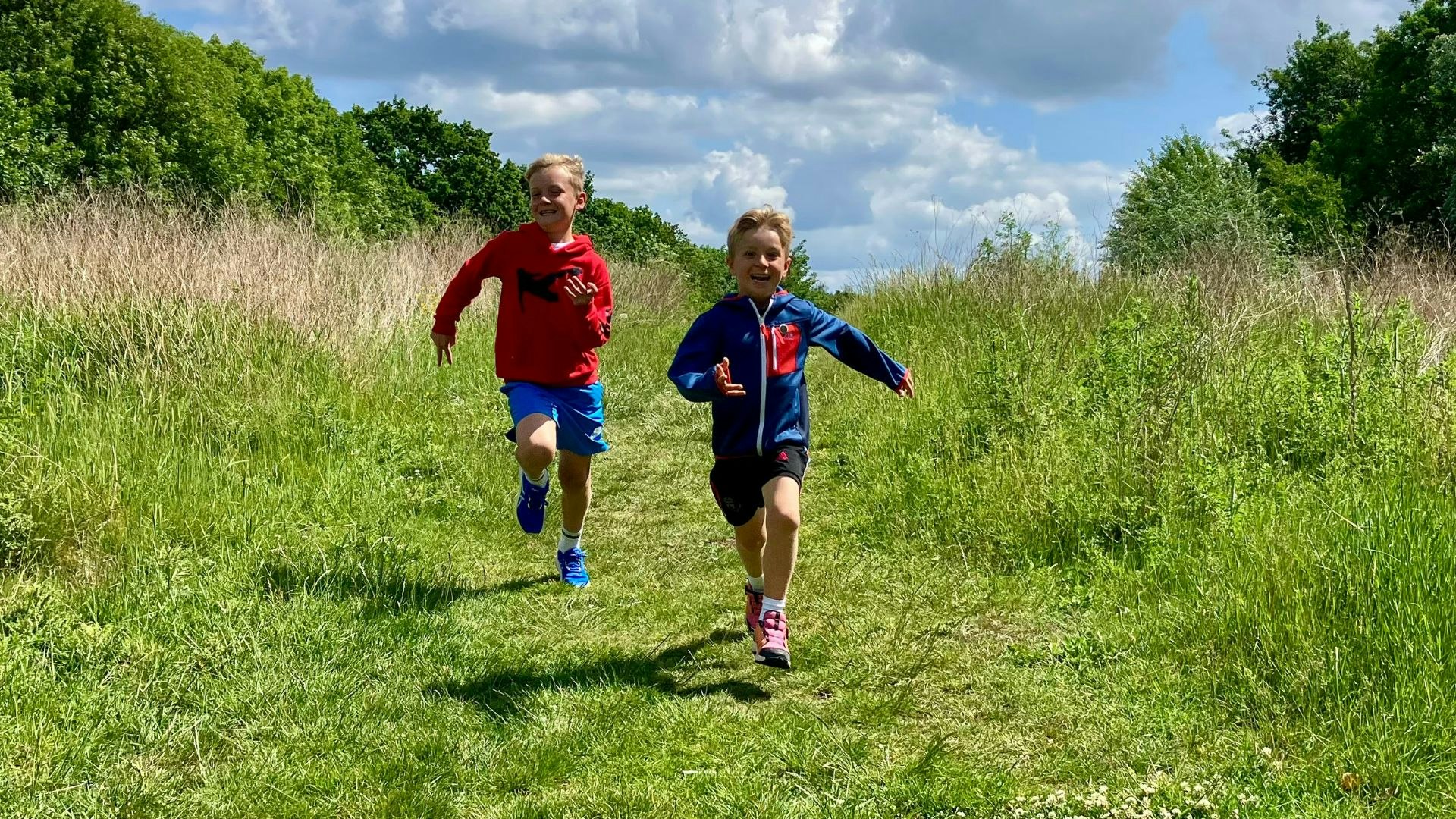 Two young boys running in kids running shoes