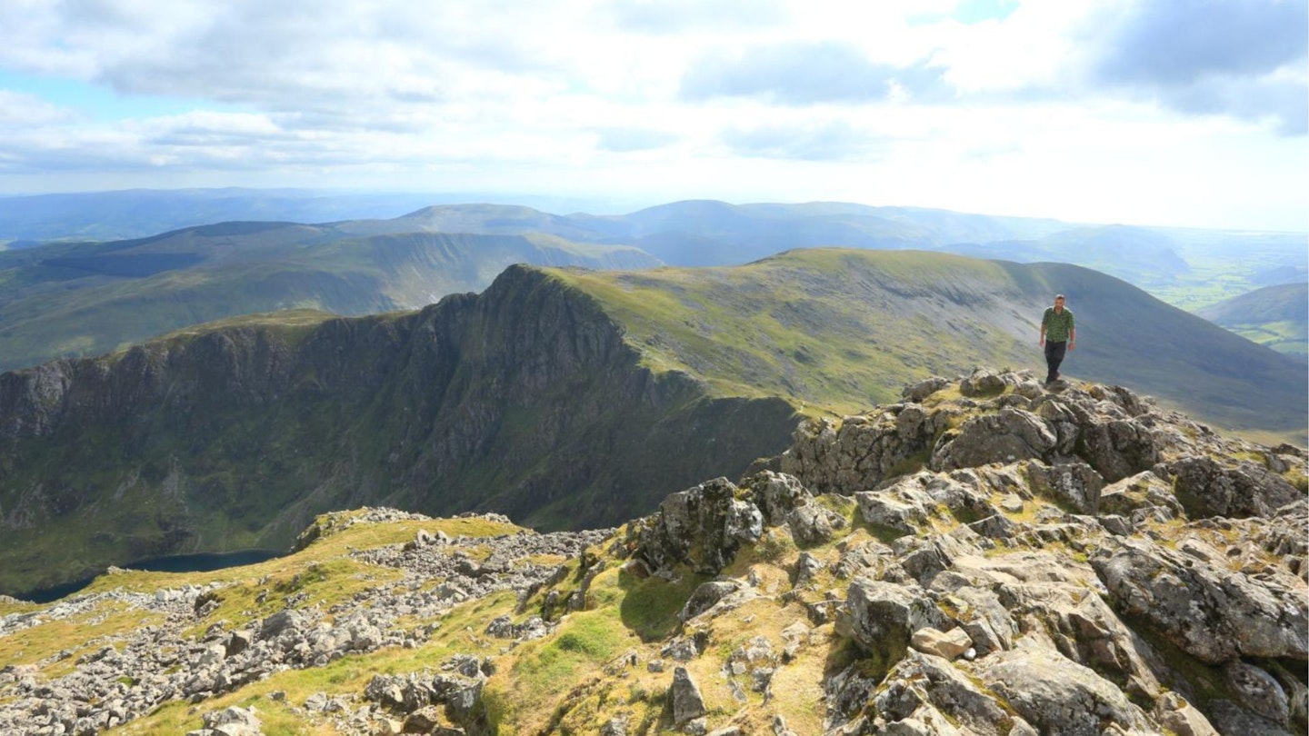 Hiker with views from the summit area of Cadair Idris Snowdonia