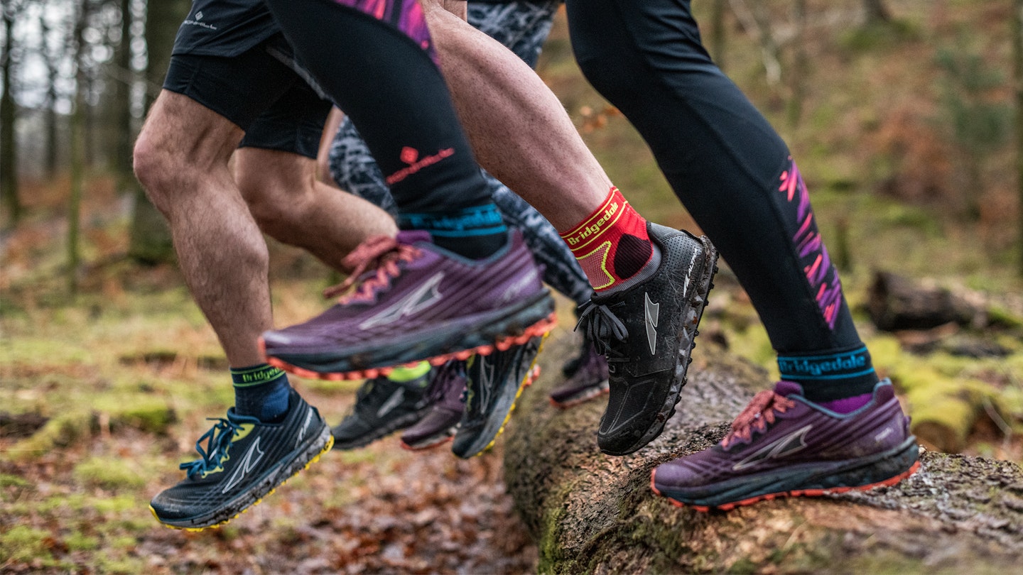 bridgedale socks in trail running shoes over a log