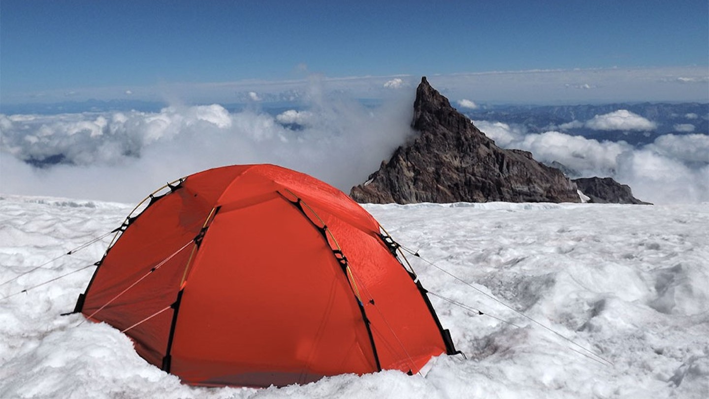 Hilleberg tent pitching on a snowy mountain summit