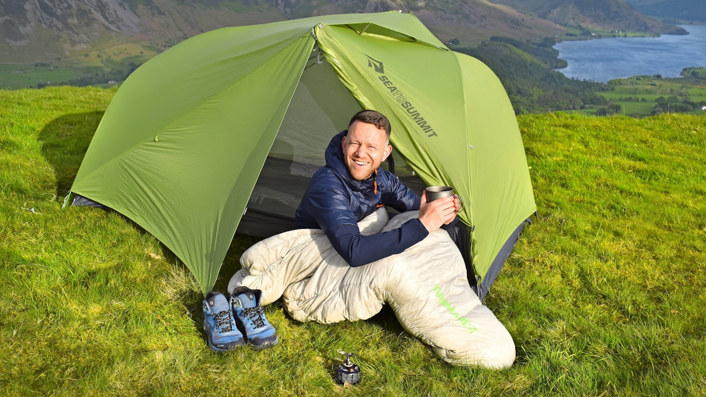 Hiker sitting in front of Sea to Summit Telos TR2 tent
