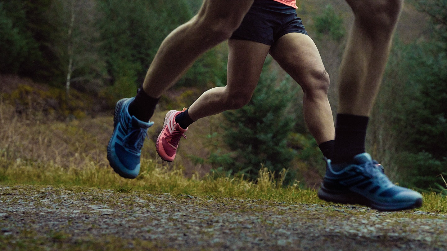 two pairs of inov8 trailfly running shoes on a gravel path