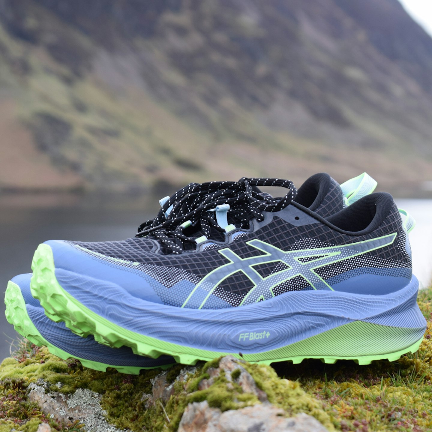 Asics Trabuco Max 3 trail running shoes posed on a rock for review