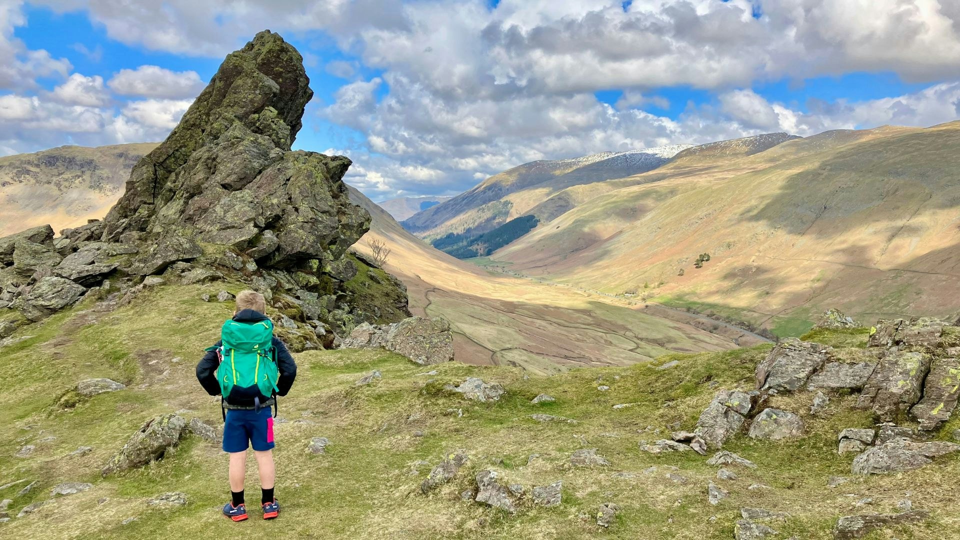 Helm Crag child looking at Howitzer Lake District