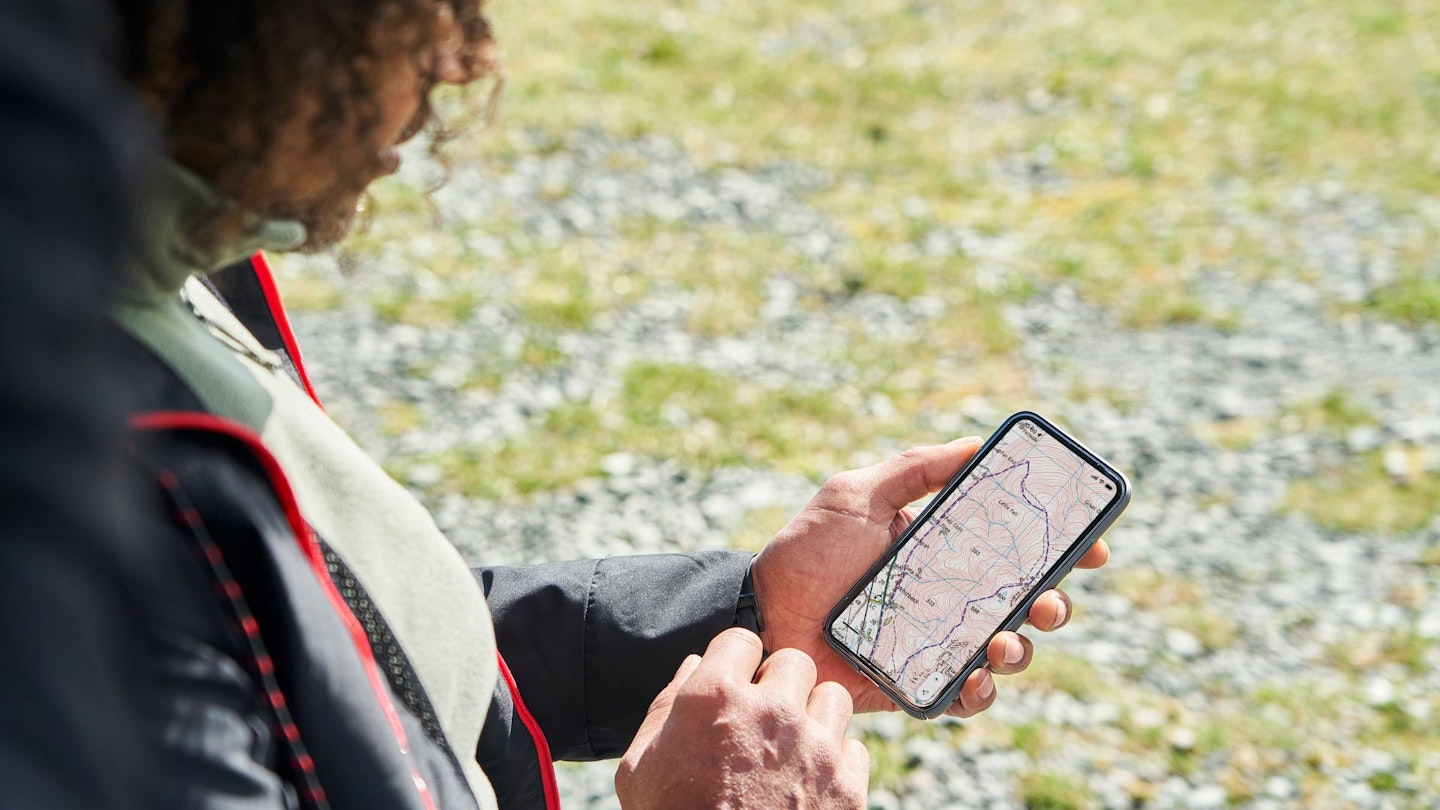 Hiker using OS Maps