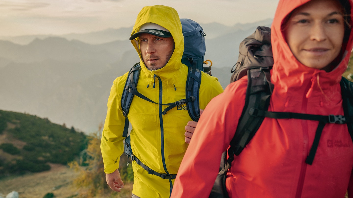 Man and woman wearing Jack Wolfskin waterproof jackets in the mountains