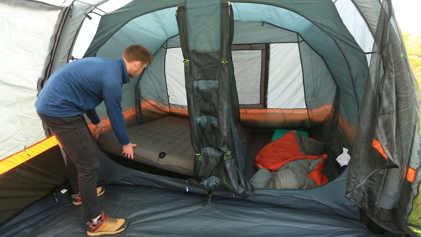 Person putting an airbed into OLPRO Blakedown Breeze 4 bedroom