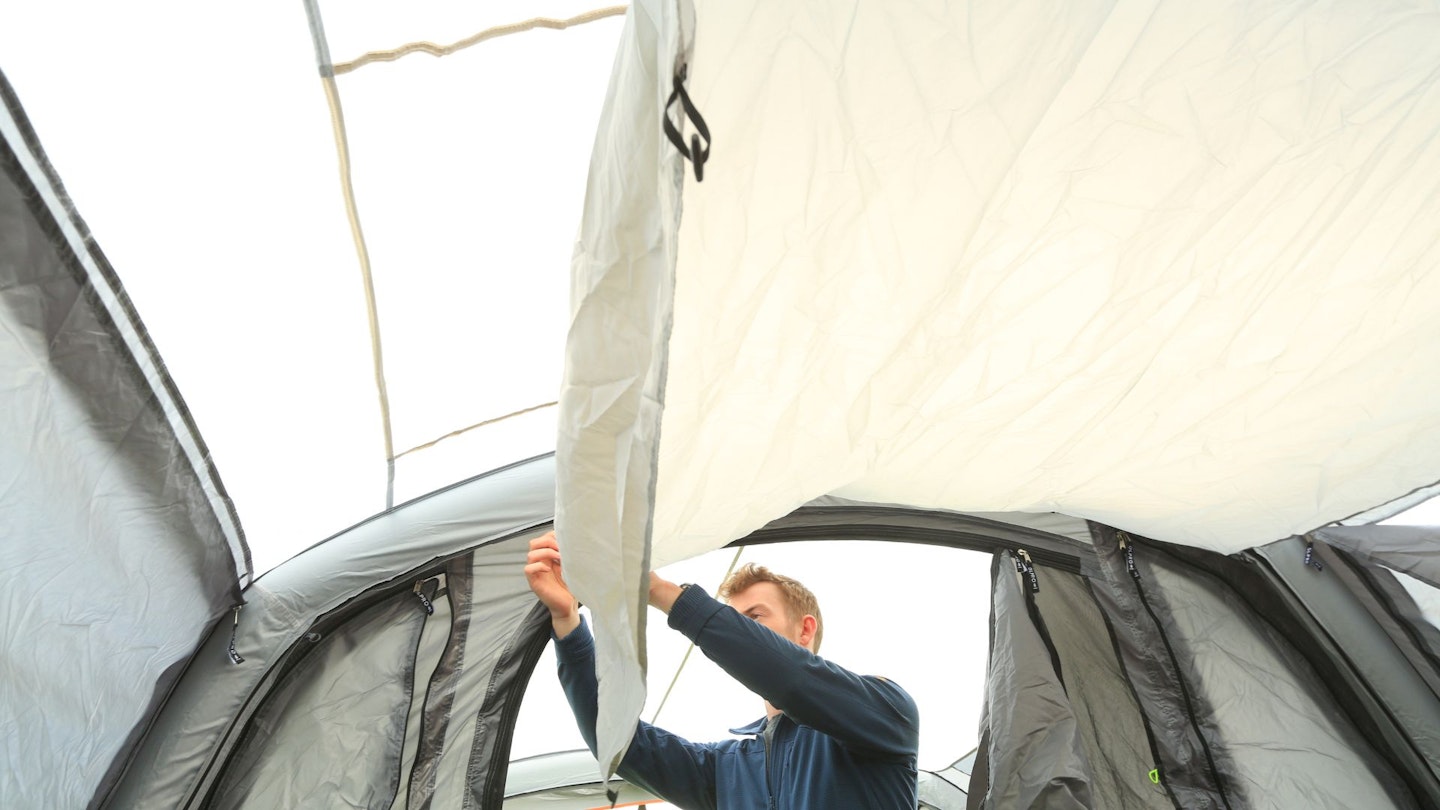 Person rolling back OLPRO Blakedown Breeze 4 celing cover to show skylight