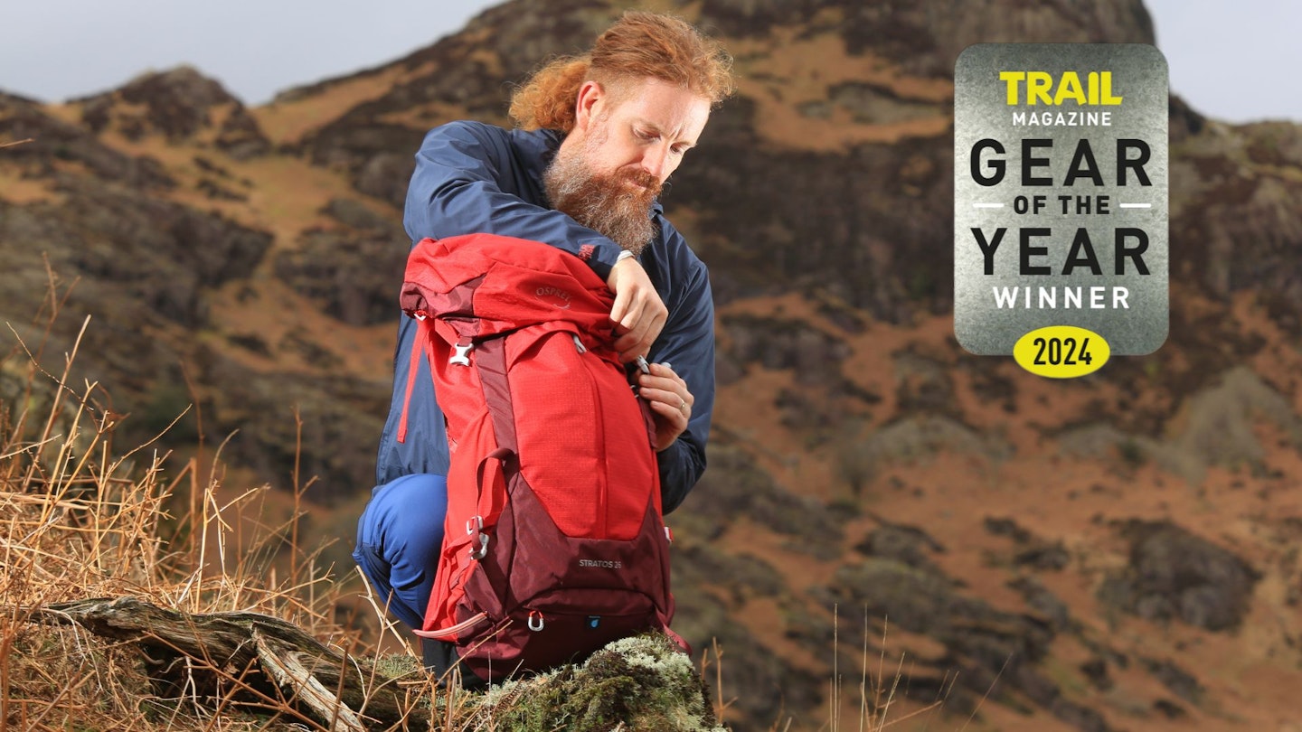 Hiker using Osprey Stratos with Gear of the Year award logo