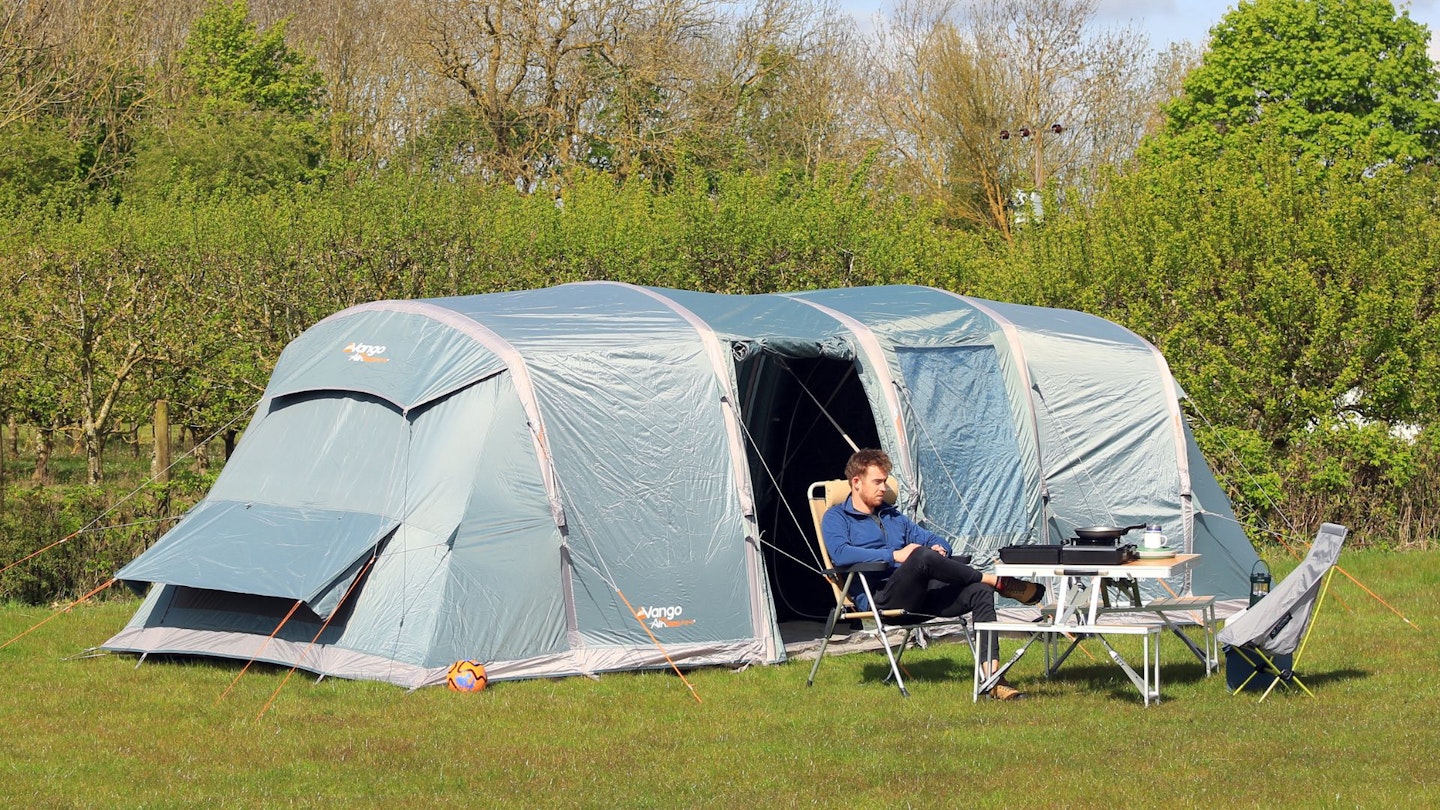 Person sitting outside Vango Castlewood Air 800XL Package