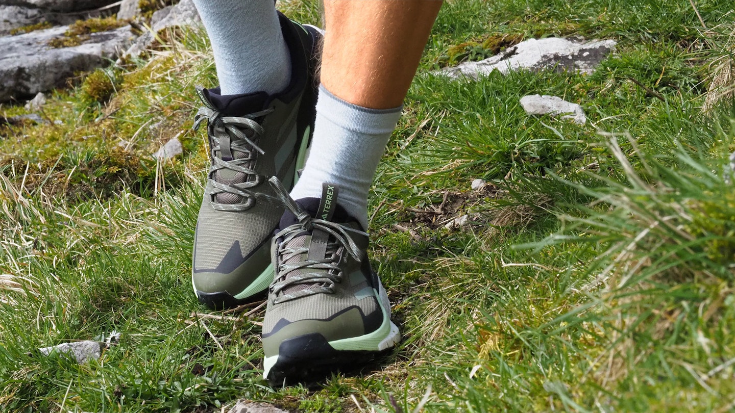 Closeup of hiker walking towards camera wearing Adidas Terrex Free Hiker 2.0 Low GTX