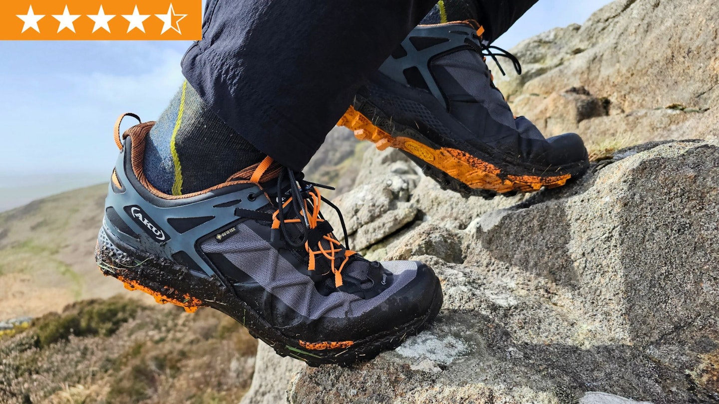 Closeup of hiker wearing AKU Rocket DFS GTX shoes, climbing a rock