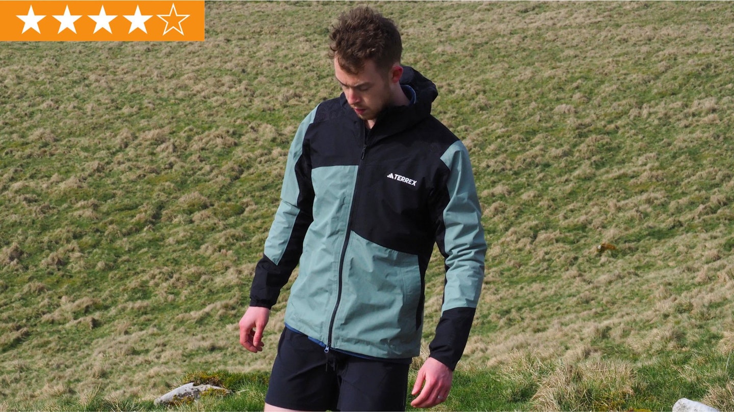Hiker walking, wearing Adidas TERREX Xperior Hybrid RAIN.RDY Jacket with LFTO star rating