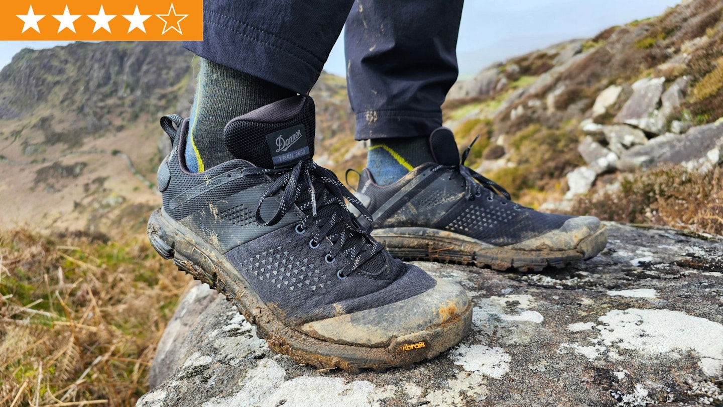 Closeup of hiker standing on a rock wearing Danner Trail 2650 GTX, flexing the shoe