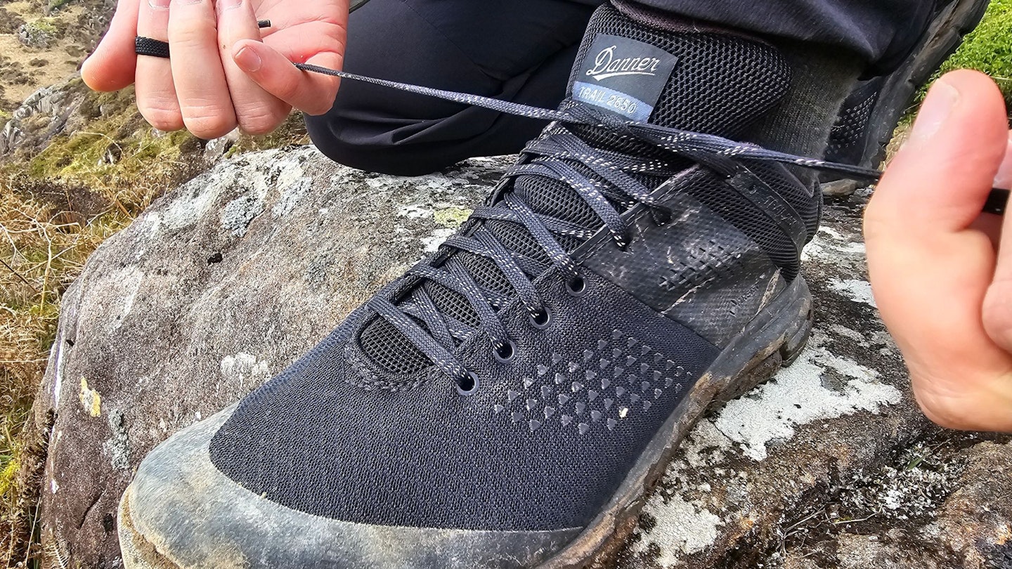 Hiker tying Danner Trail 2650 GTX laces