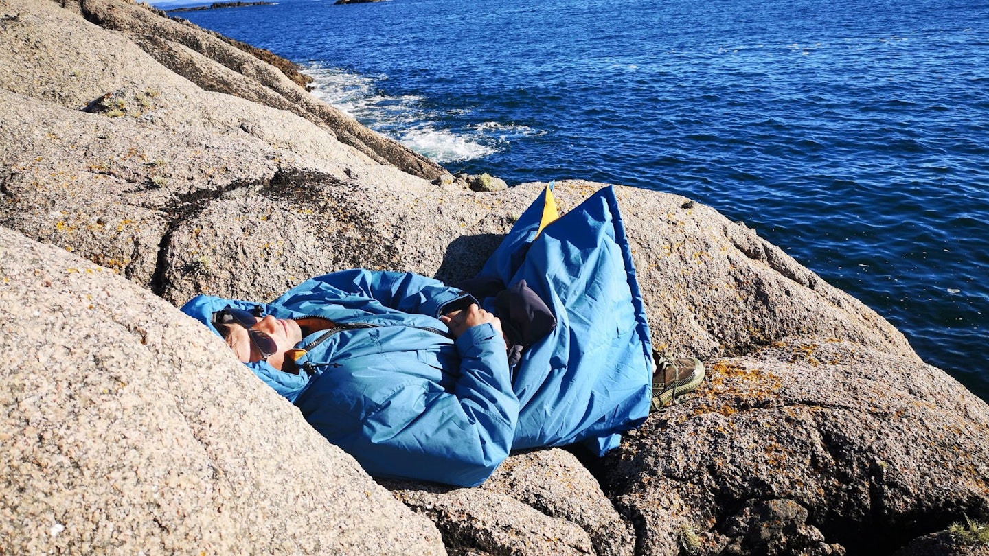 Dougie snoozing in the sunshine wearing a voited dryrobe