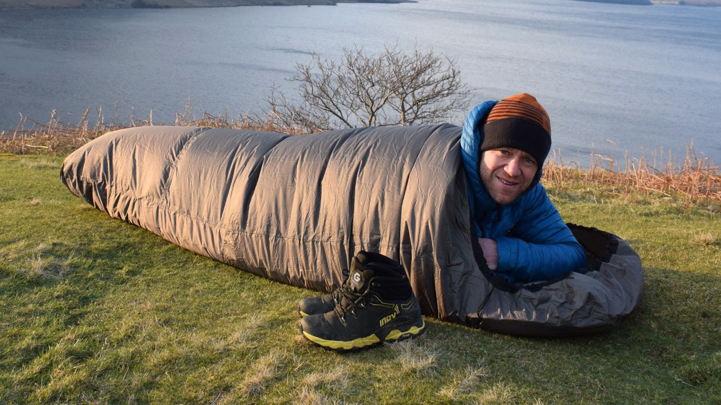 James Forrest lying down in Mountain Warehouse Waterproof Bivvy Bag