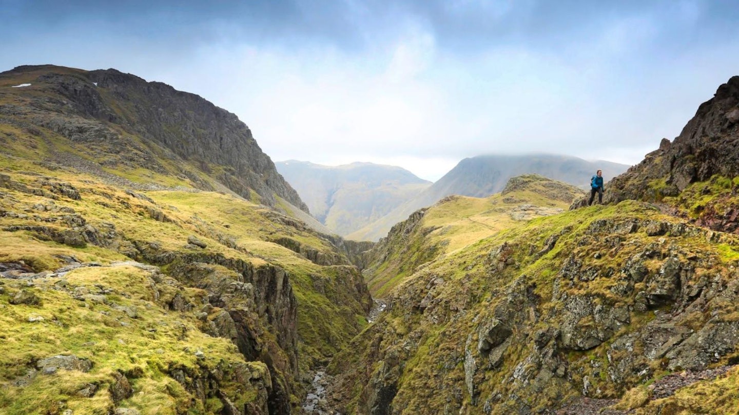 Hiker above Piers Gill on the Scafell Pike Corridor Route in the Lake District