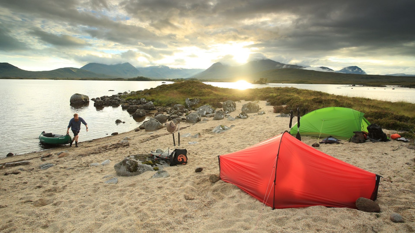 Red hooped tent and a vaude hogan on the beach in scotland