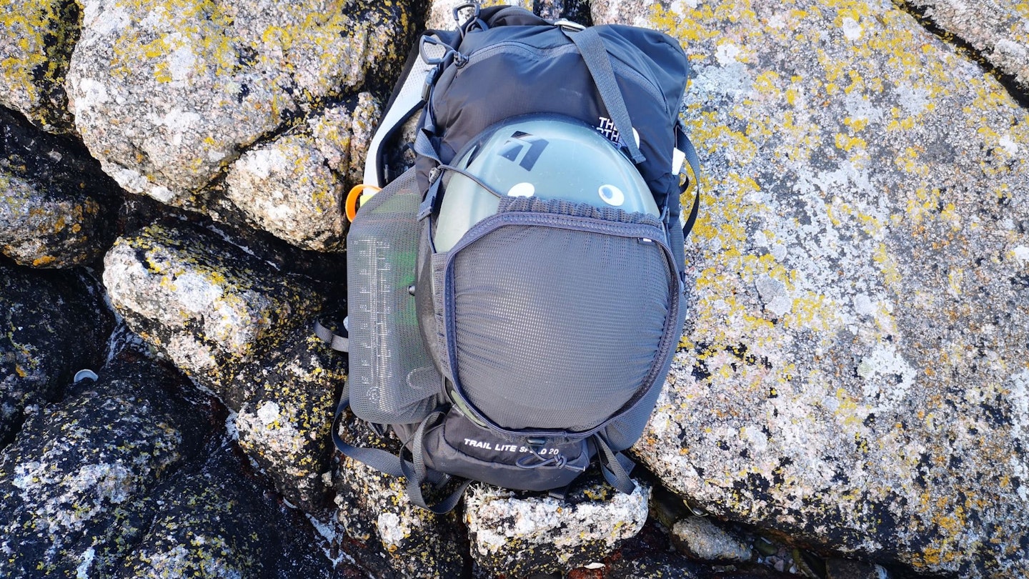 north face trail lite backpack helmet holder holding a helmet