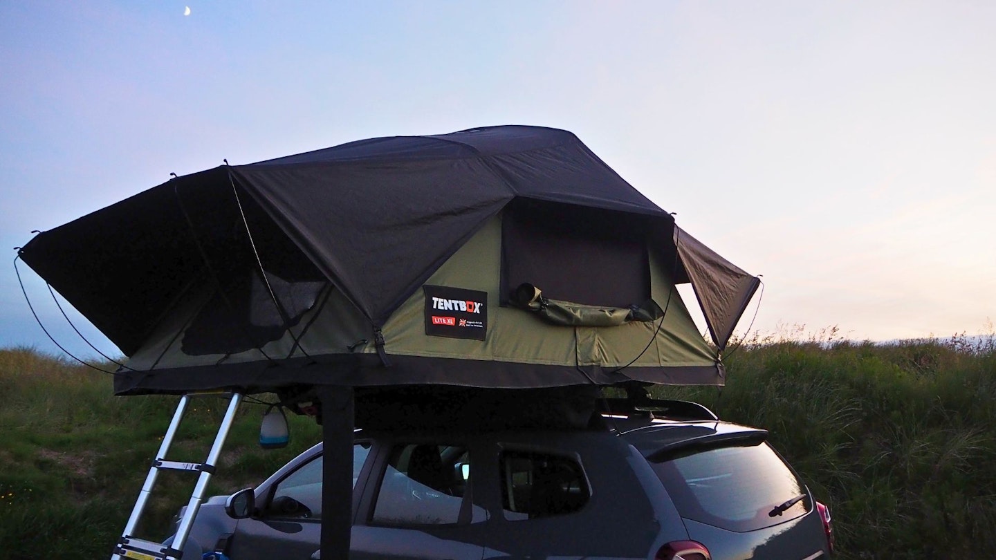 TentBox Lite XL pitched on car roof at dusk