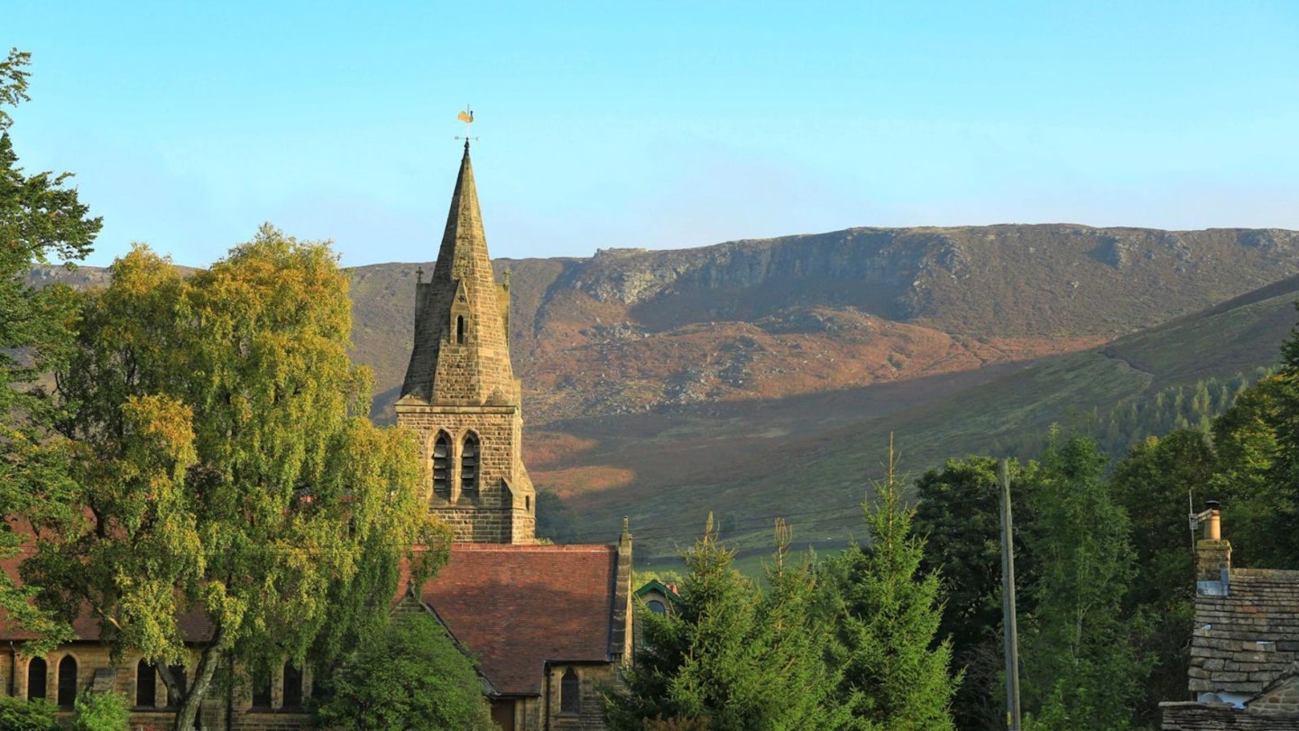 Edale Church spire in the foreground of Kinder Scout