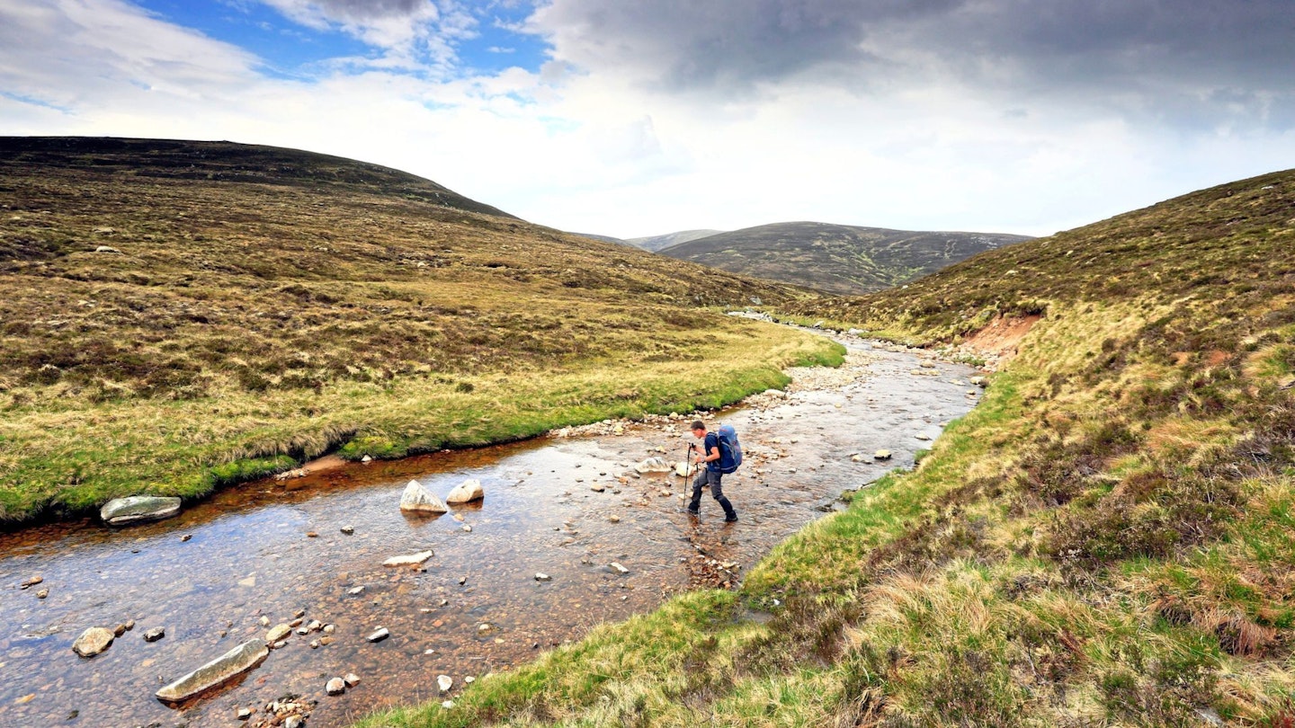 Crossing Tarf Water north of Loch Mhairc Cairngorms