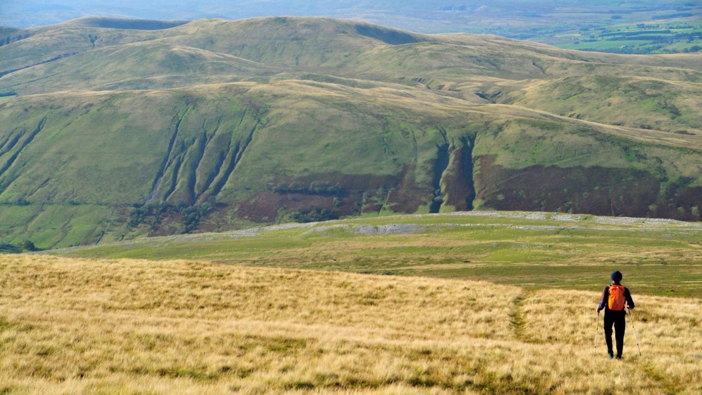 Descending from the summit with the Howgill Fells in the background